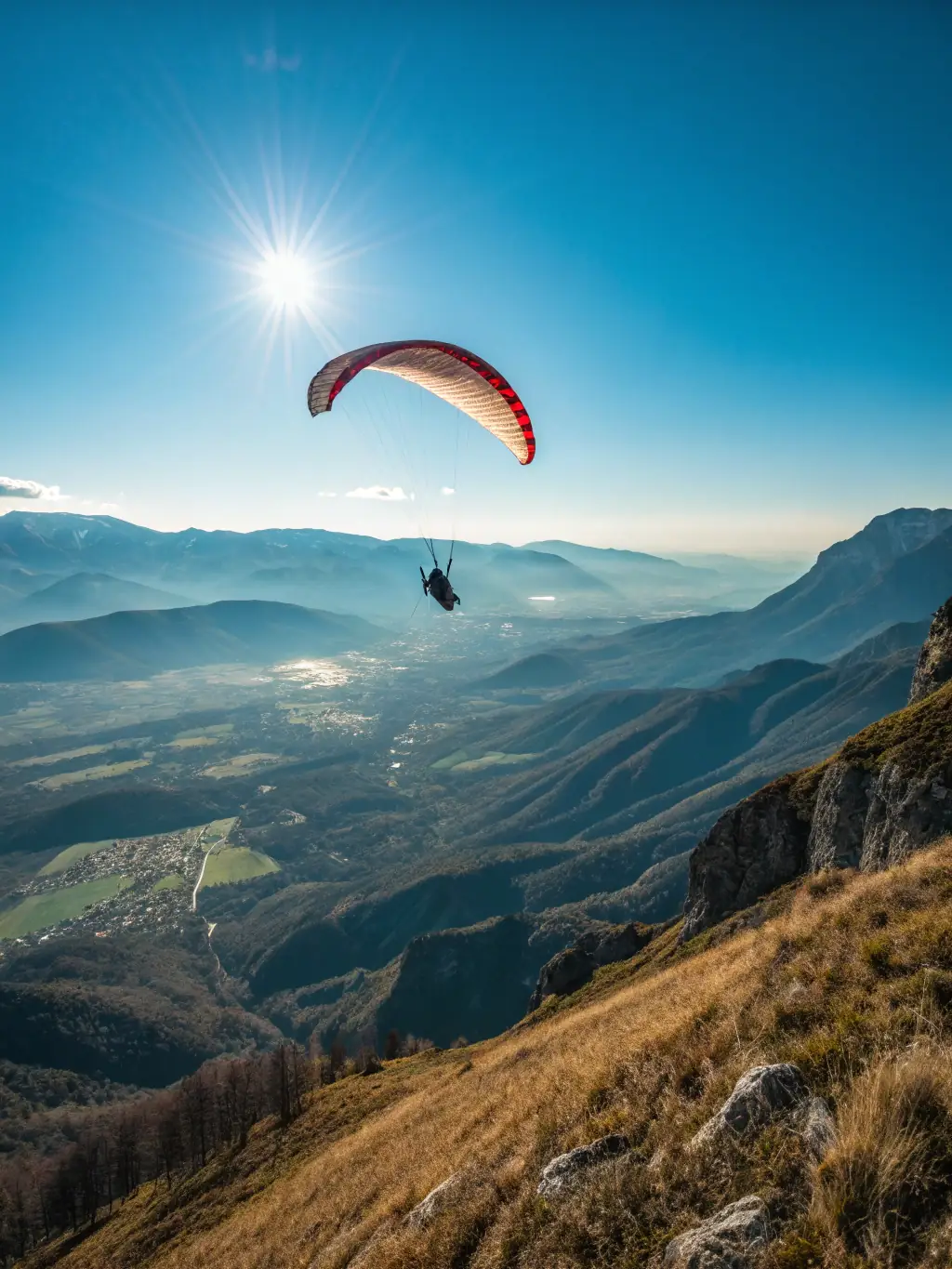 A group of paragliders soaring gracefully over a lush green valley, showcasing the freedom and excitement of the sport, to illustrate the thrill of skill development.