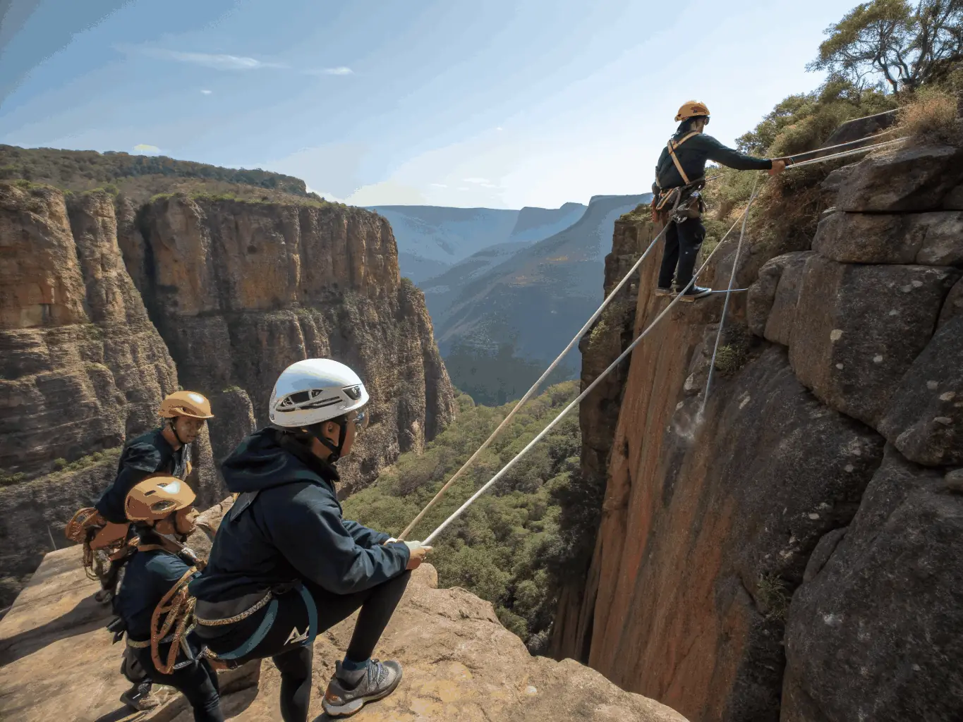 A group of paragliding students are gathered on a hilltop, receiving instruction from a certified instructor. The students are attentively listening and preparing their gear, with the picturesque landscape of the Limousin region visible in the background.